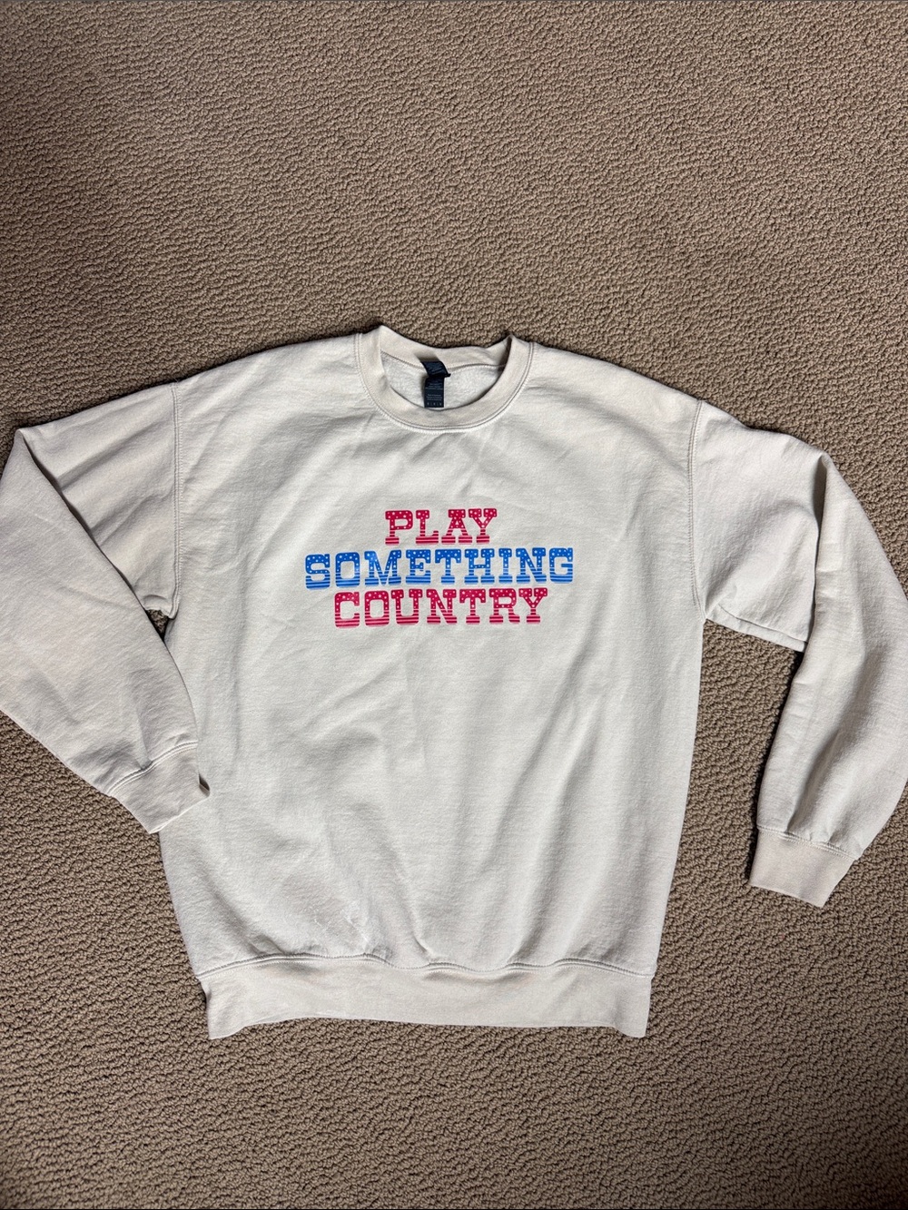 Gildan tan Crewneck Sweatshirt with Red and Blue 'Play Something Country' Text